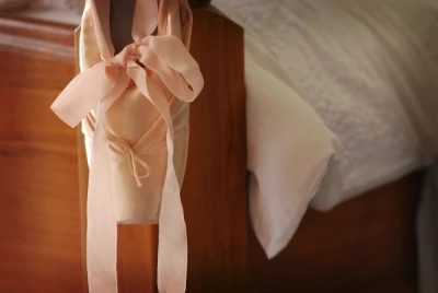 image of ballerina shoe hanging on bed