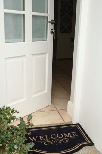 Open front door with welcome mat  