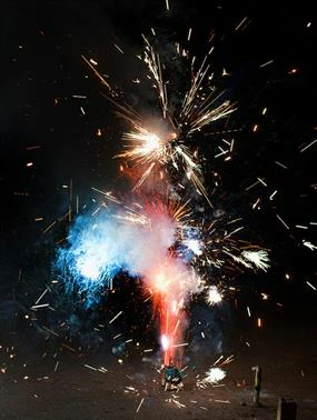 Photo of a firework exploding in red, white, and blue sparks