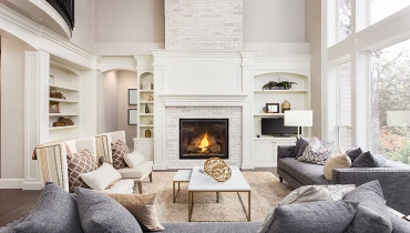 Gorgeous living room painted white with fireplace and bay windows