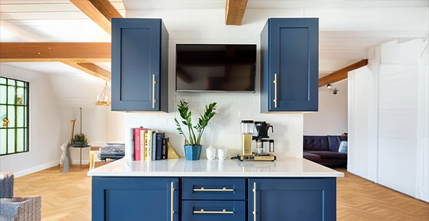 A picture of freshly painted blue kitchen cabinets.