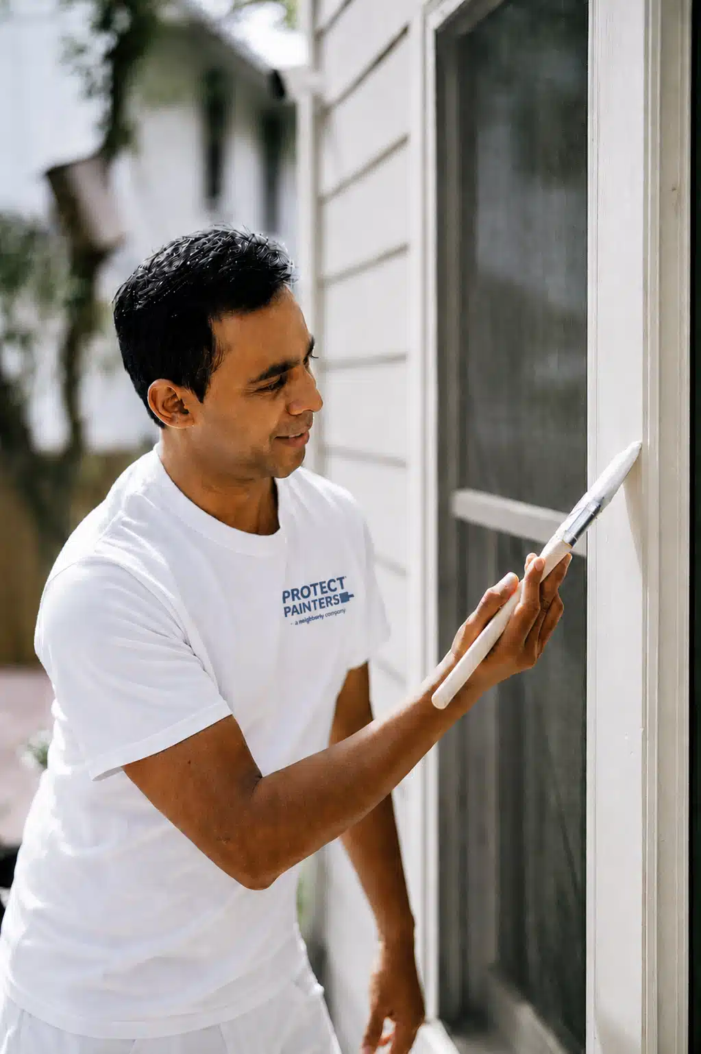 ProTect Painters professional painting exterior window trim during outdoor painting services