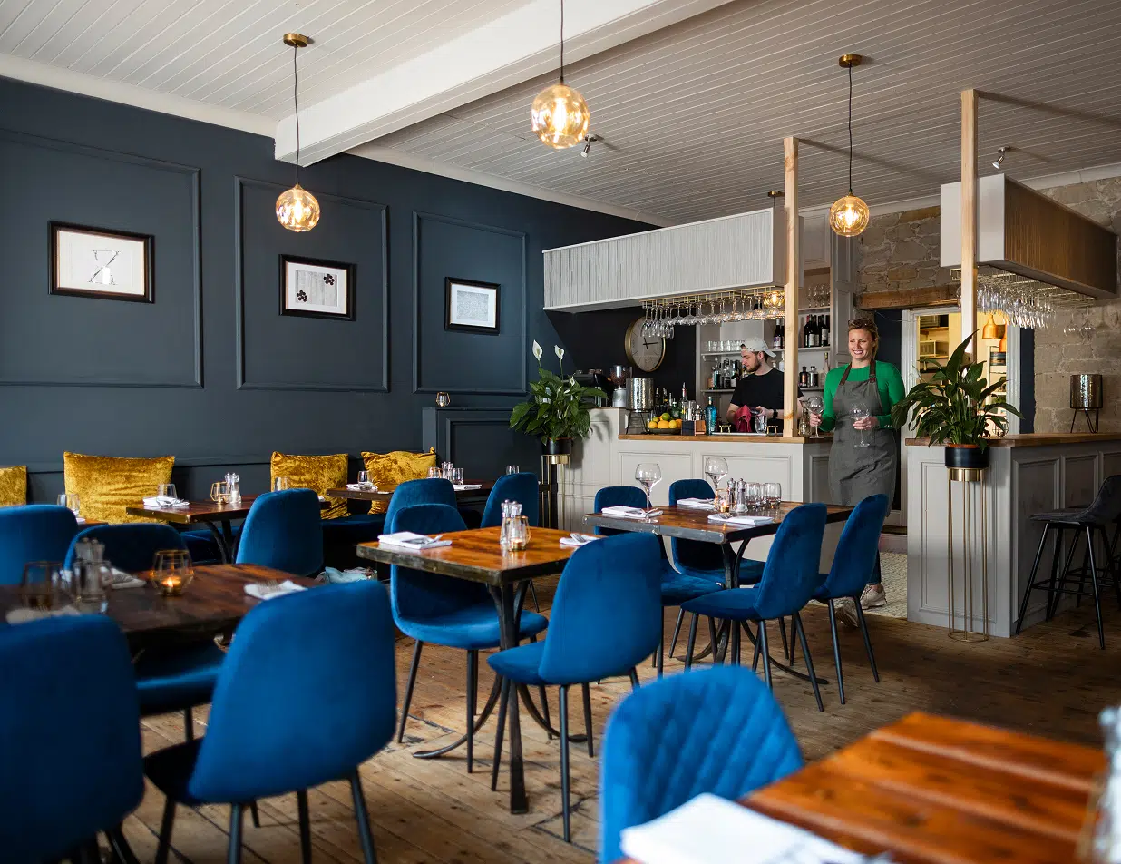 Restaurant dining room with deep navy paneled walls, showcasing commercial painting services by Five Star Painting