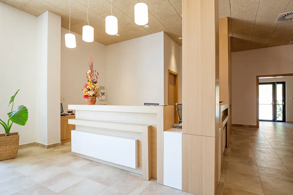 Bright office reception area with clean white walls, showcasing business painting services by Five Star Painting