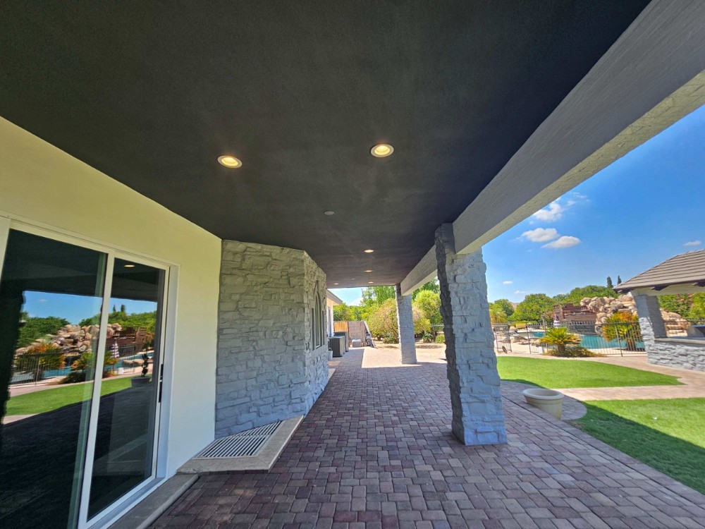 Photo of a large Arizona back patio painted with a pool in the background