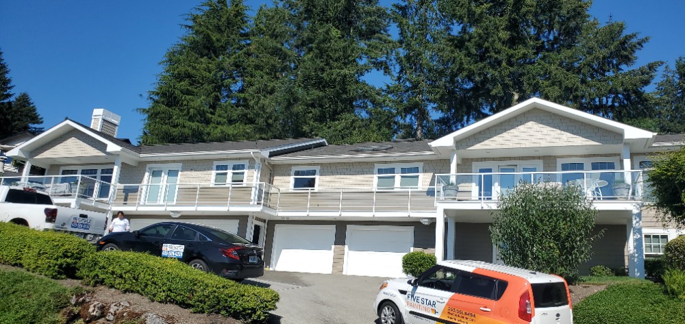 Two Story Duplex with Single and Double Garage Doors with Vehicles in driveway