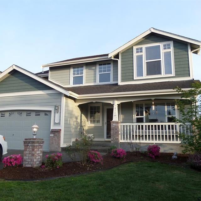 Two Story Home with Front Porch Railings and Posts