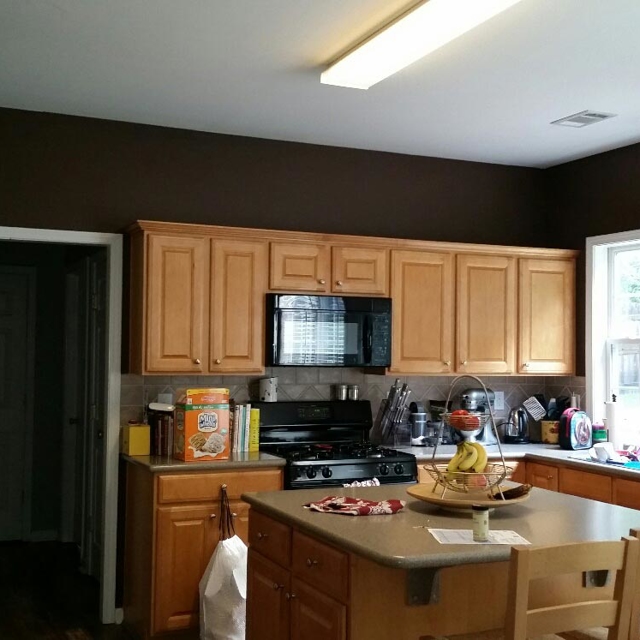 Kitchen with chesnut brown wooden cabinets.