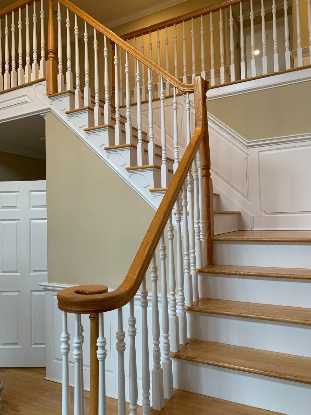 Matawan foyer and stairs painted in classic beige with white trim