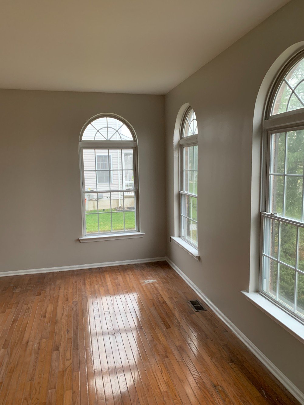 Well-lit living room in Metuchen, NJ with freshly painted light-colored walls