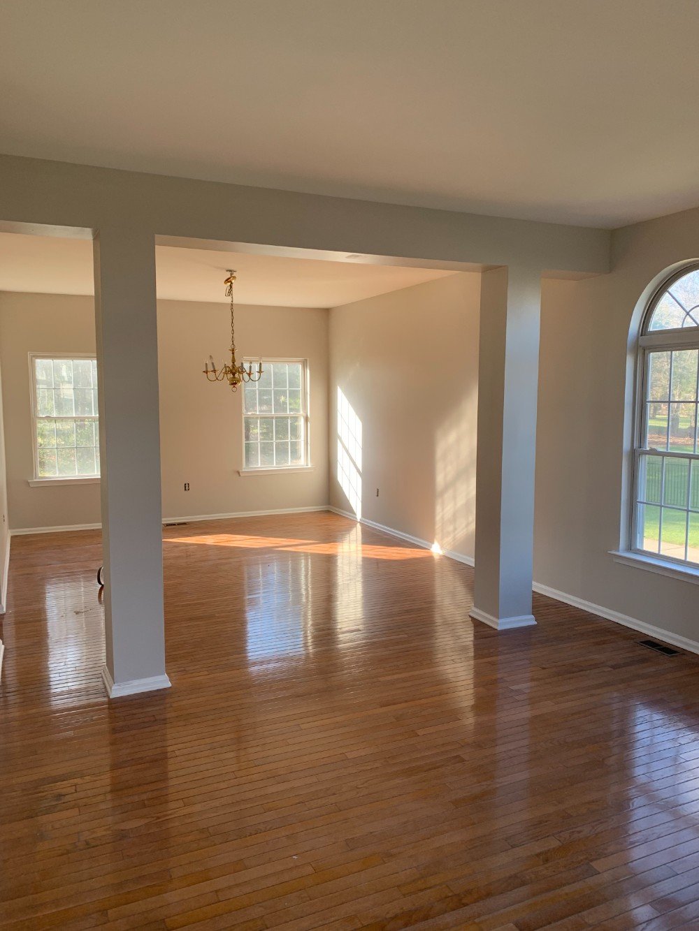 Well-lit living room, in Metuchen, NJ with freshly painted light-colored walls