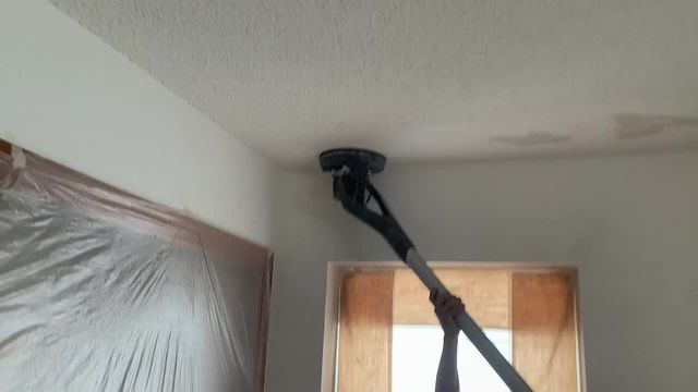 Ceiling sander performing popcorn ceiling removal. This machine helps to minimize the dust by up to 70%.