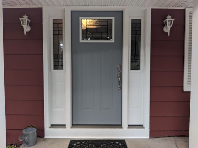 grey door on red house