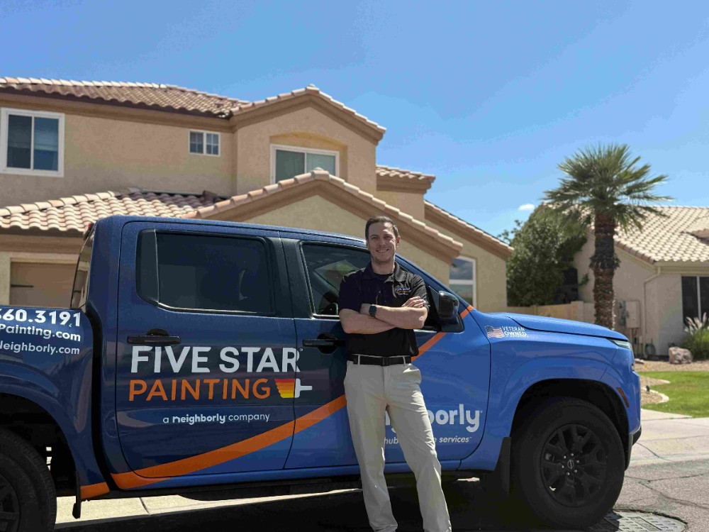 Owner in front of a home painted by Five Star Painting of East Valley. We offer high-quality, professional, interior and exterior residential painting and commercial painting services.