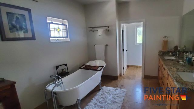 white bathroom with granite counter a white bathtub