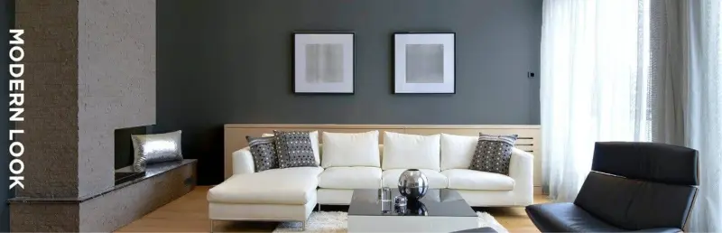 Living Room in shades of taupe, forest green and tan featuring furniture and paintings on walls.