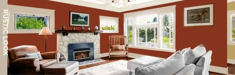 Rustic style living room in tan, red and brown featuring furniture and paintings on walls.