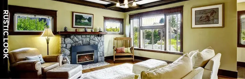 Rustic style living room in original colours of yellow featuring furniture and paintings on walls.