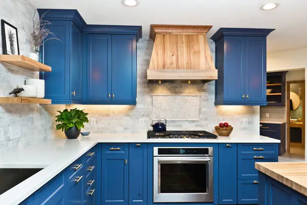 A kitchen with blue cabinets.