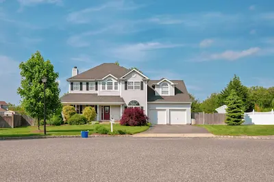 Large two-story home with manicured lawn.