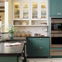 modern kitchen with green cabinets.