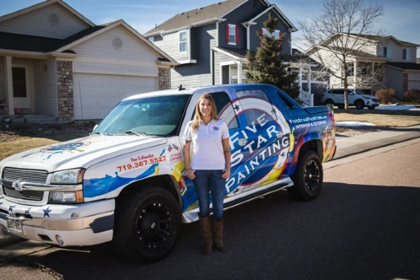 Photo of Sarah in front of a Five Star Painting truck.