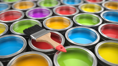 Colorful cans of paint with paint brush.
