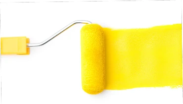 Yellow paint roller following a trail of yellow paint on a white background