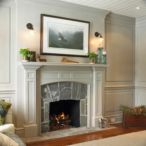 Fireplace with a painting over it