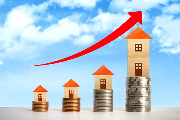 Red arrow pointing upwards as houses stacked on coins increase.
