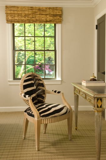 Faux zebra fur upholstered desk chair with neutral wood arms and legs  