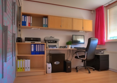 Office with plentiful light wood cabinets for organized storage  