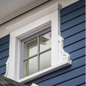 White framed window on a blue house