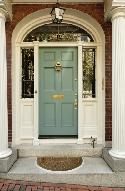 Attractive Front Pork with Olive Green Door, Columns, and Brick Accents