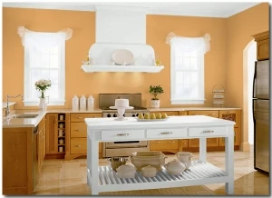 Kitchen with light orange walls and white accents
