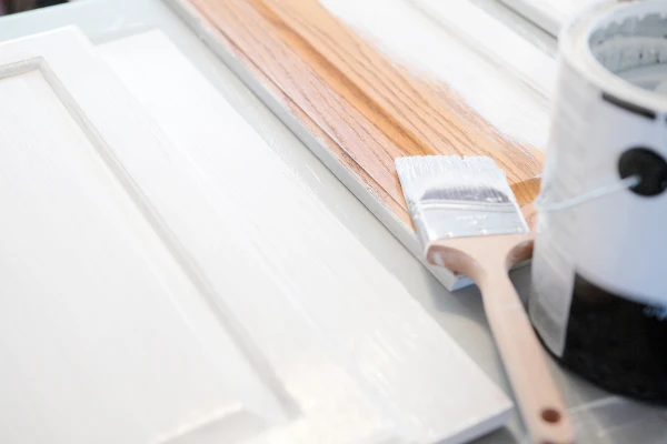 Can of paint opened on a cabinet.