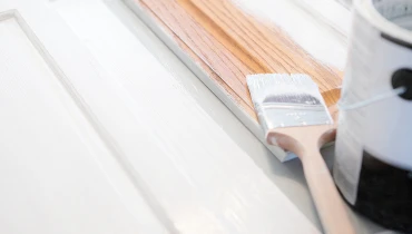 Can of paint opened on a cabinet.