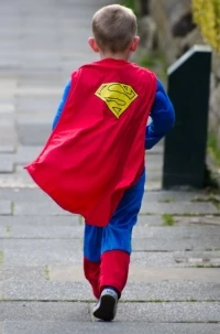 Picture of a small boy dressed in a Superman costume