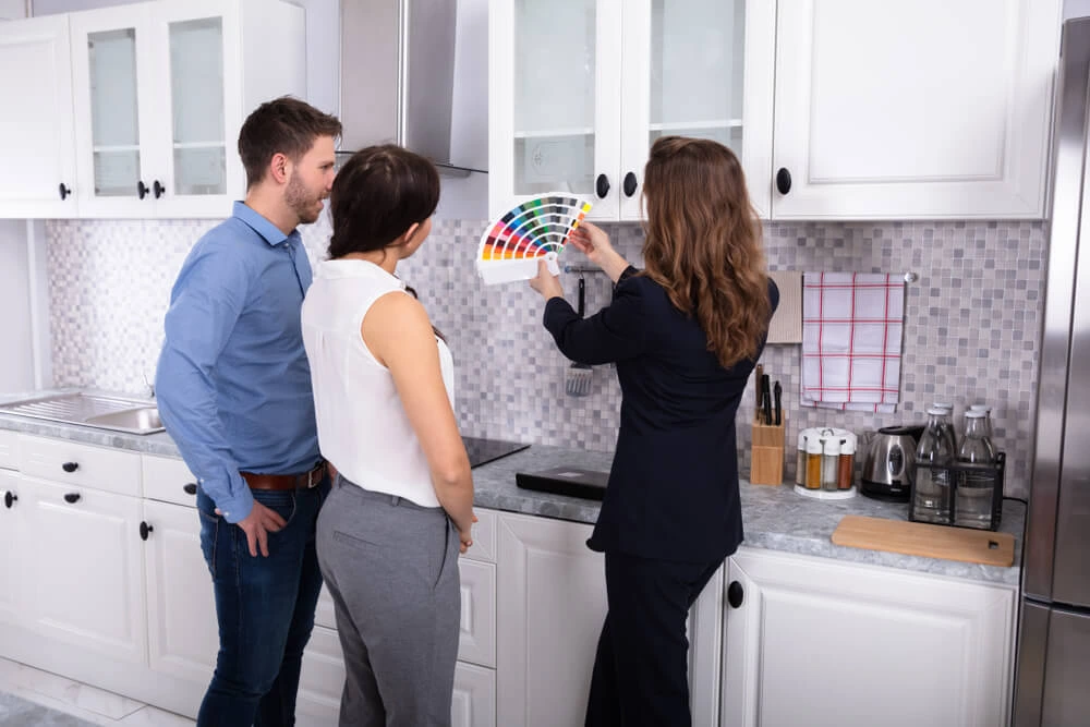 Couple viewing color swatches with an expert.