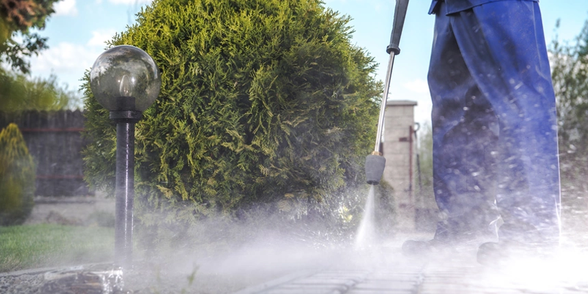 Blog title superimposed over a person pressure washing a wooden deck, Five Star Painting logo in the top right of the photo