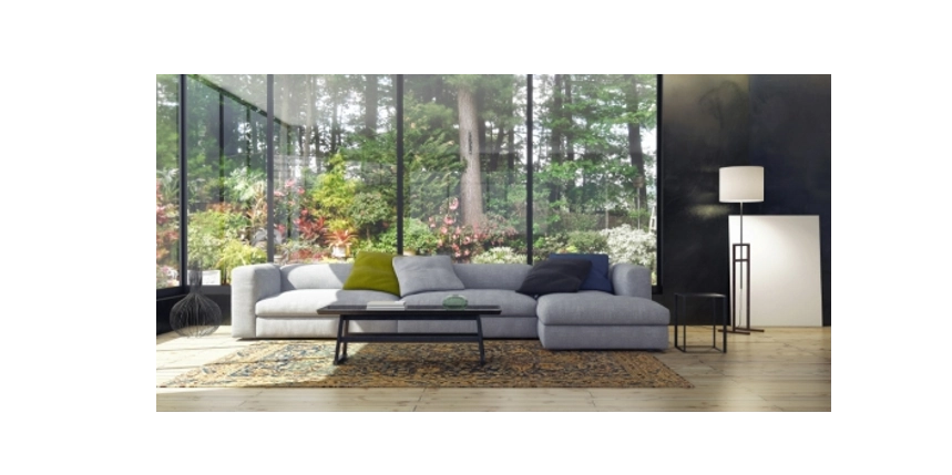 Photo of a living room with a large window looking out onto a copse of trees