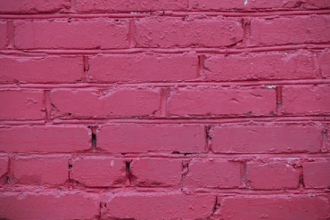 Brick wall painted with red paint