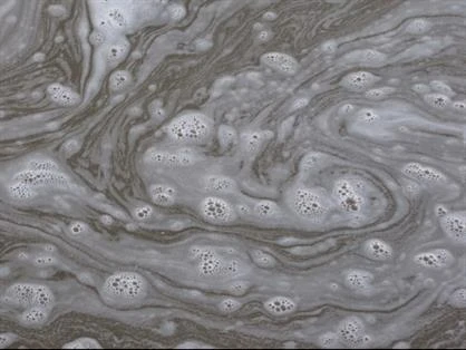 Soapy water swirling on a concrete surface.