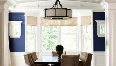 Dining room with wooden floors viewed through an archway