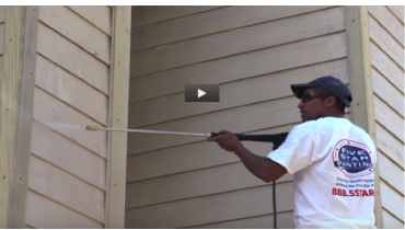 Photo of a Five Star Painting employee painting the outside of a house