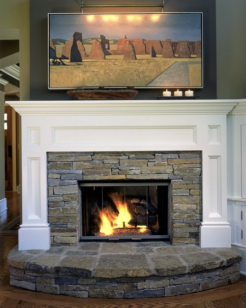 Fireplace with a painting over it
