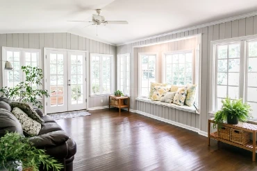 Large and open sunroom with windows on two sides and lots of natural light flowing in