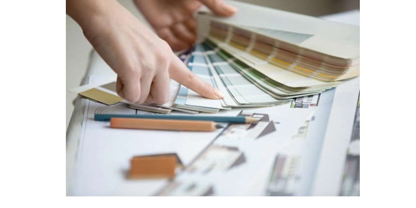 loseup of woman pointing to color on a color palette chart