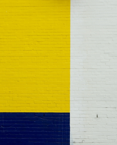 Yellow, blue, and white brick wall