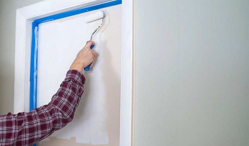 Person painting bedroom door